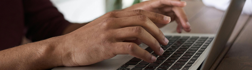 hands typing on a laptop